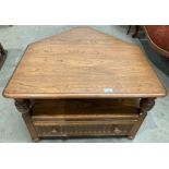 An Ercol medium elm entertainment stand with single drawer and lift top triangular back flap 72cm x