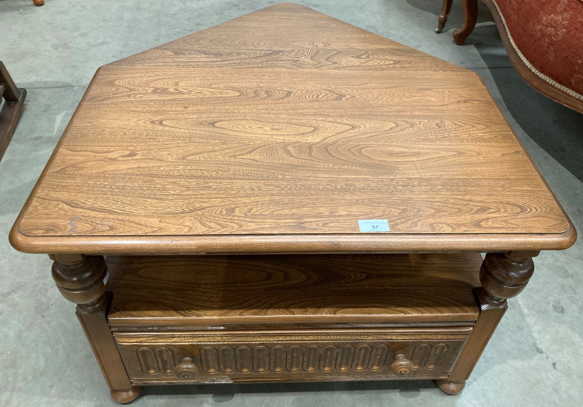 An Ercol medium elm entertainment stand with single drawer and lift top triangular back flap 72cm x