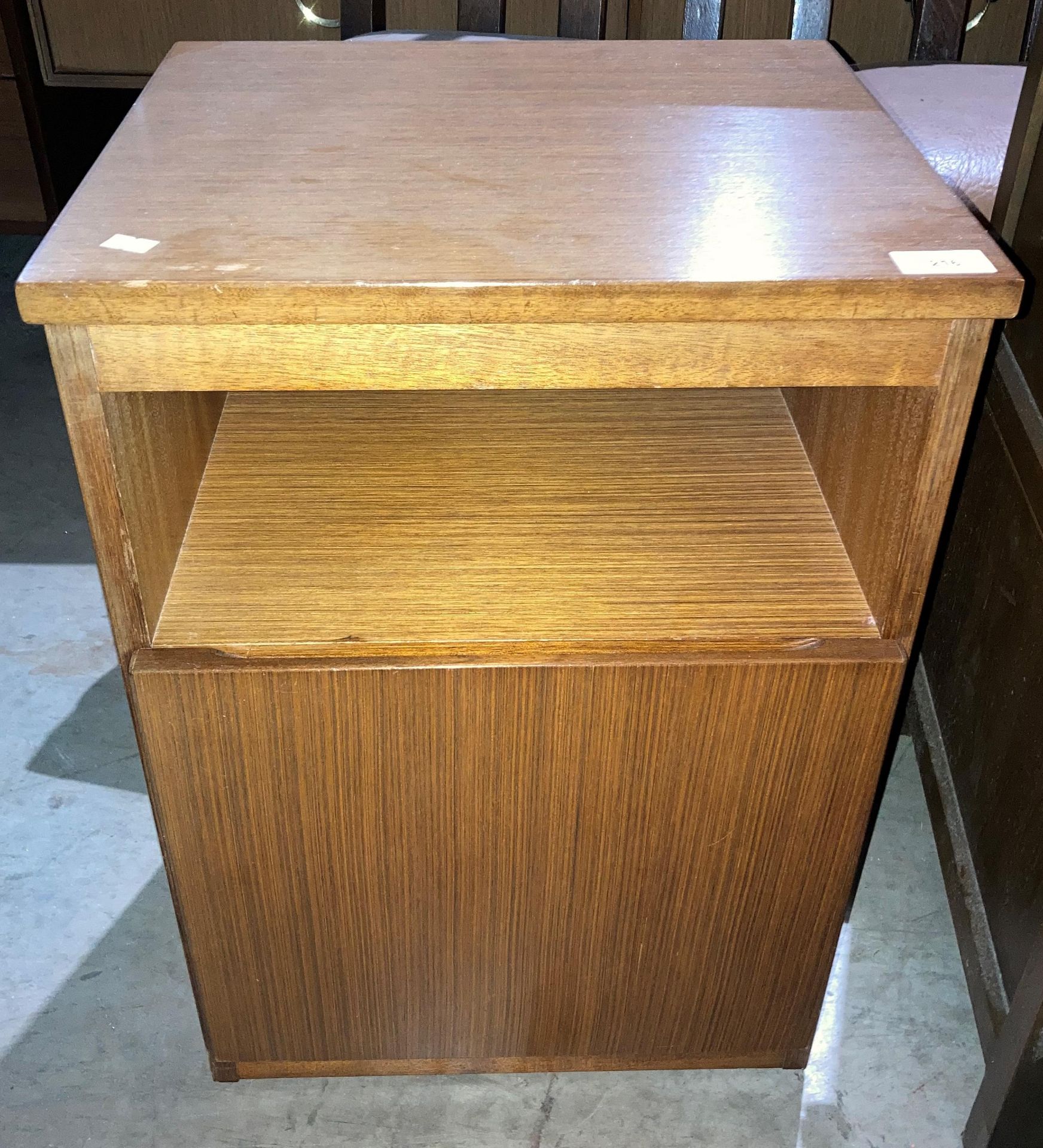 A Meredew teak single door bedside cabinet