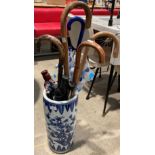A Chinese style blue and white patterned umbrella/stick stand 45cm high containing umbrellas and