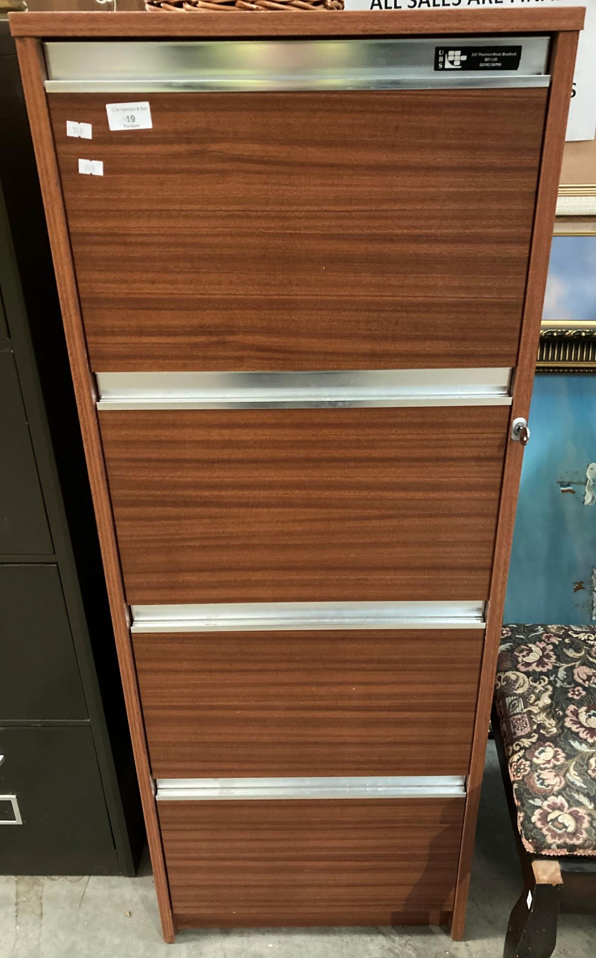 A UPS Sapele finish four drawer filing cabinet with key Further Information