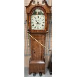 A cottage oak cased long case clock with painted face signed S Gat....