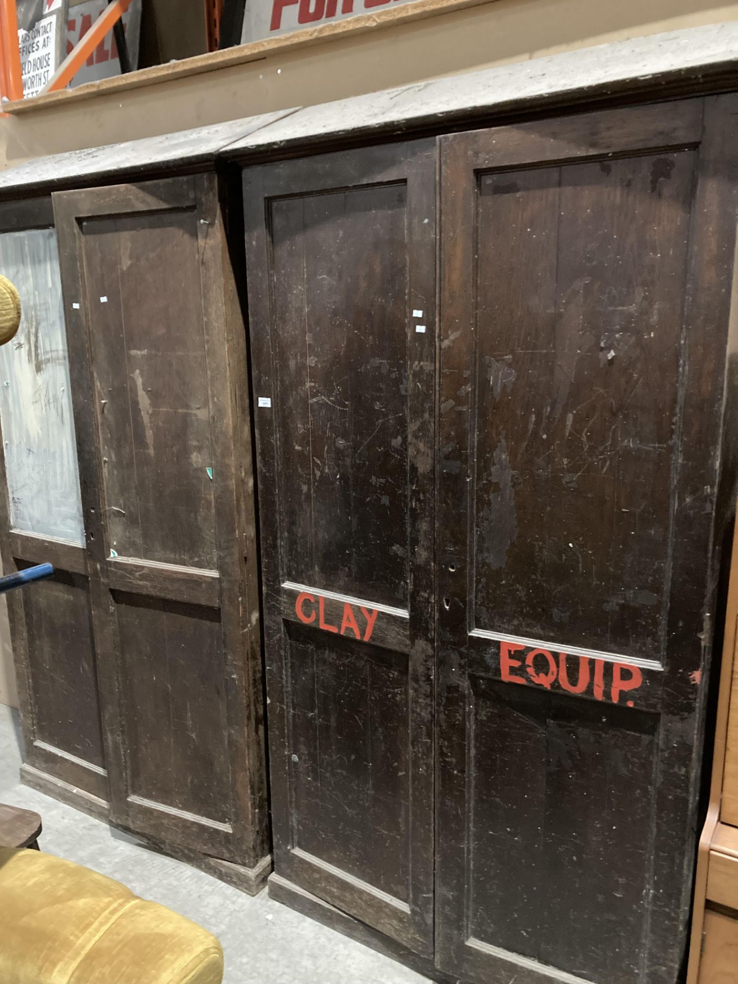 A pair of stained pine tall five shelf storage cupboards with sloped roofs each 110cm x 36cm x