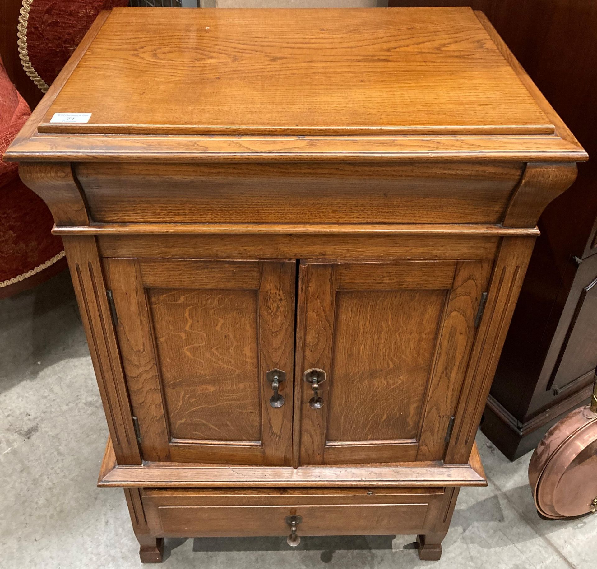 An oak cabinet with hinged top over two door single drawer base 60cm x 92cm high