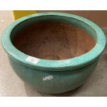 A green glazed terracotta planter 42cm diameter