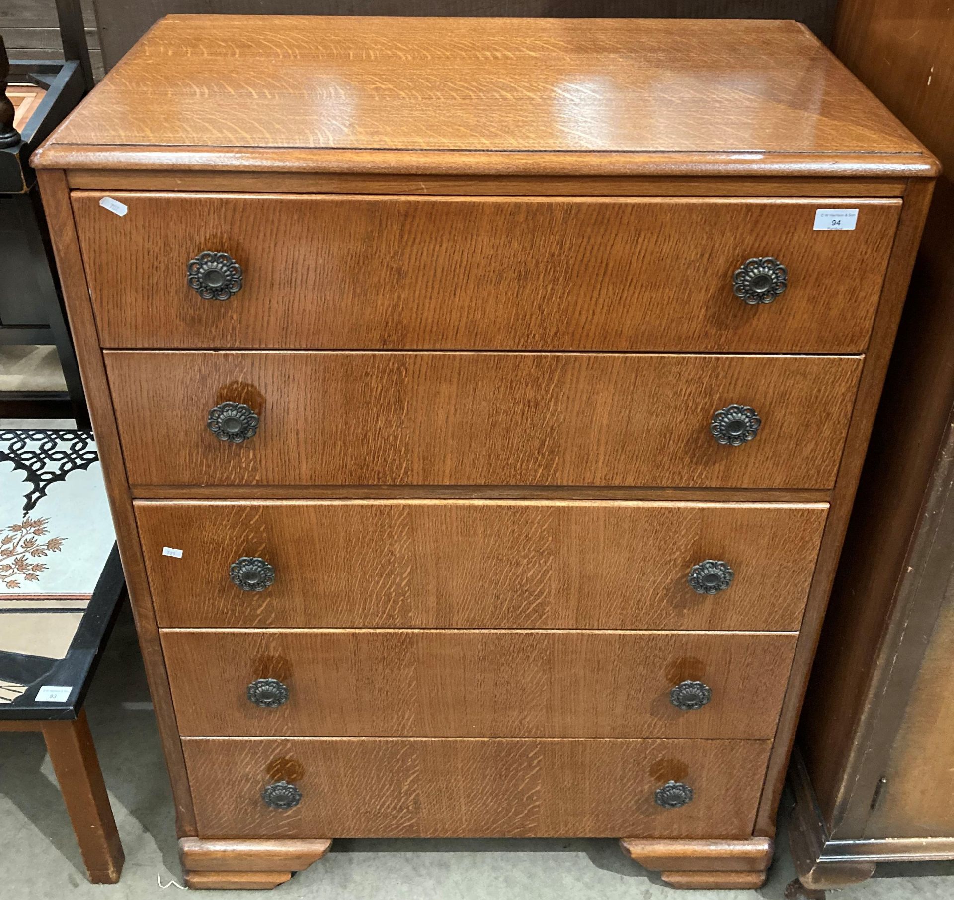 An oak veneered five drawer chest of drawers 85cm x 113cm high