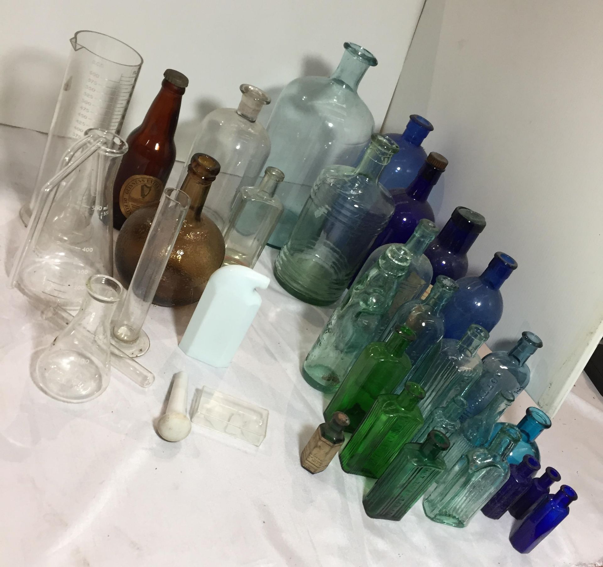 A plastic box and contents - 30+ collection of Chemist glassware including 9 blue bottles,