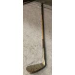 A wood handled putter - four iron golf club inscribed P.G.C.
