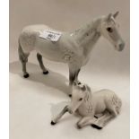 A Beswick dapple grey horse 22cm long and a matching foal - laid down 13cm long