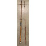A two piece cane fishing rod 9' long complete with green bag