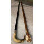 An ebonised walking stick with silver collar and horn handle, 90cm long,