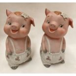 A pair of porcelain pig money banks - one with chips to rear slit and both missing stoppers,