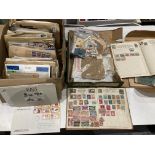 A box containing a quantity of loose used stamps and small stamp albums