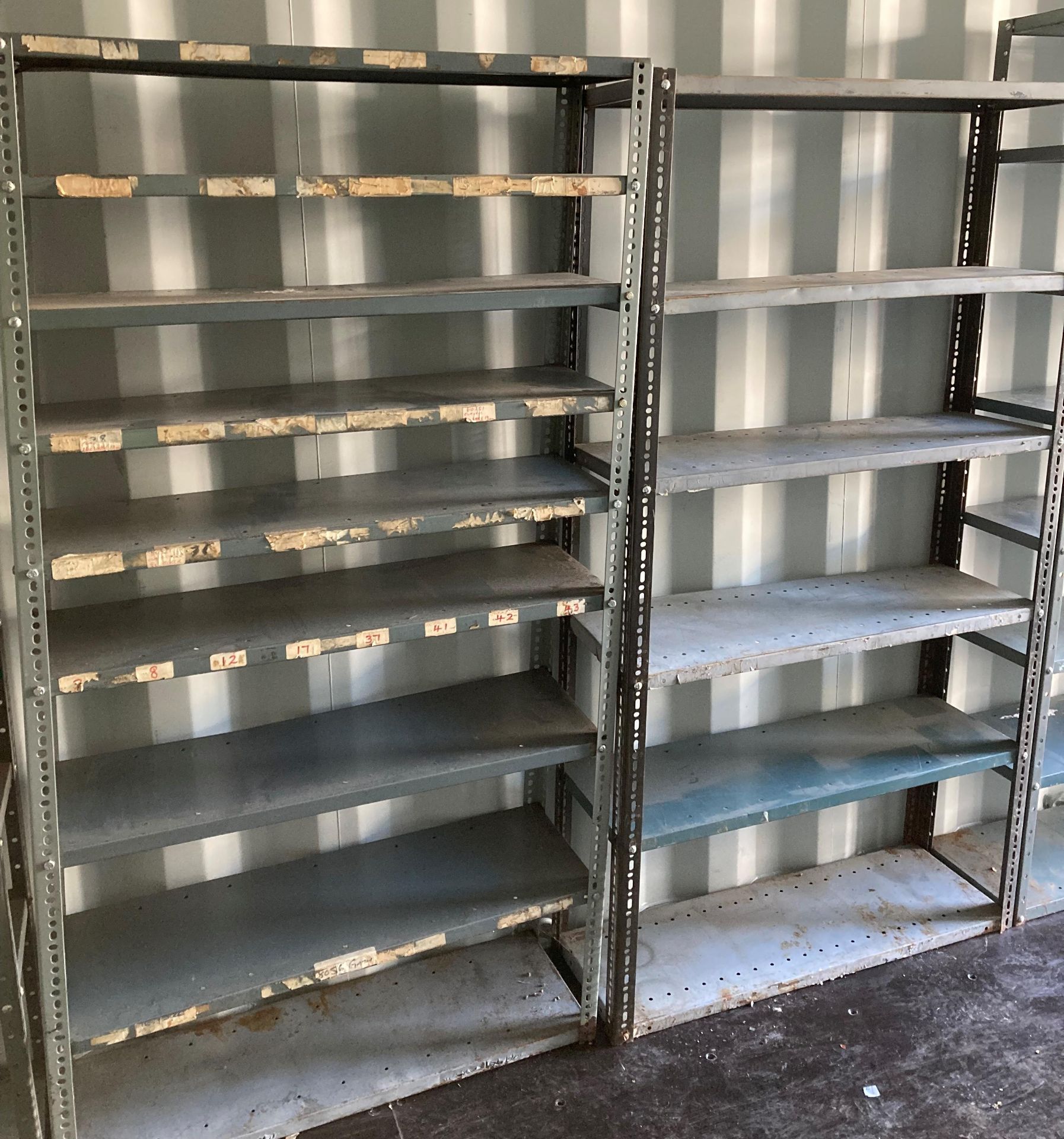 Nine shelf grey metal storage rack H: 173cm x W: 92cm x W: 31cm and a 6 shelf grey metal storage