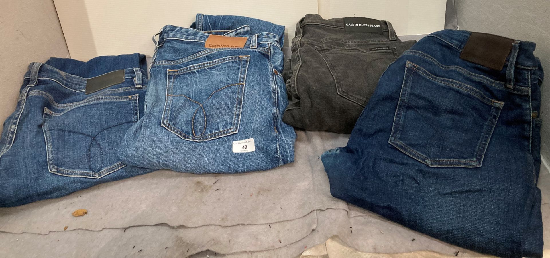 Four pairs of worn jeans by Calvin Klein assorted sizes including W34 and W32 etc *Please note the