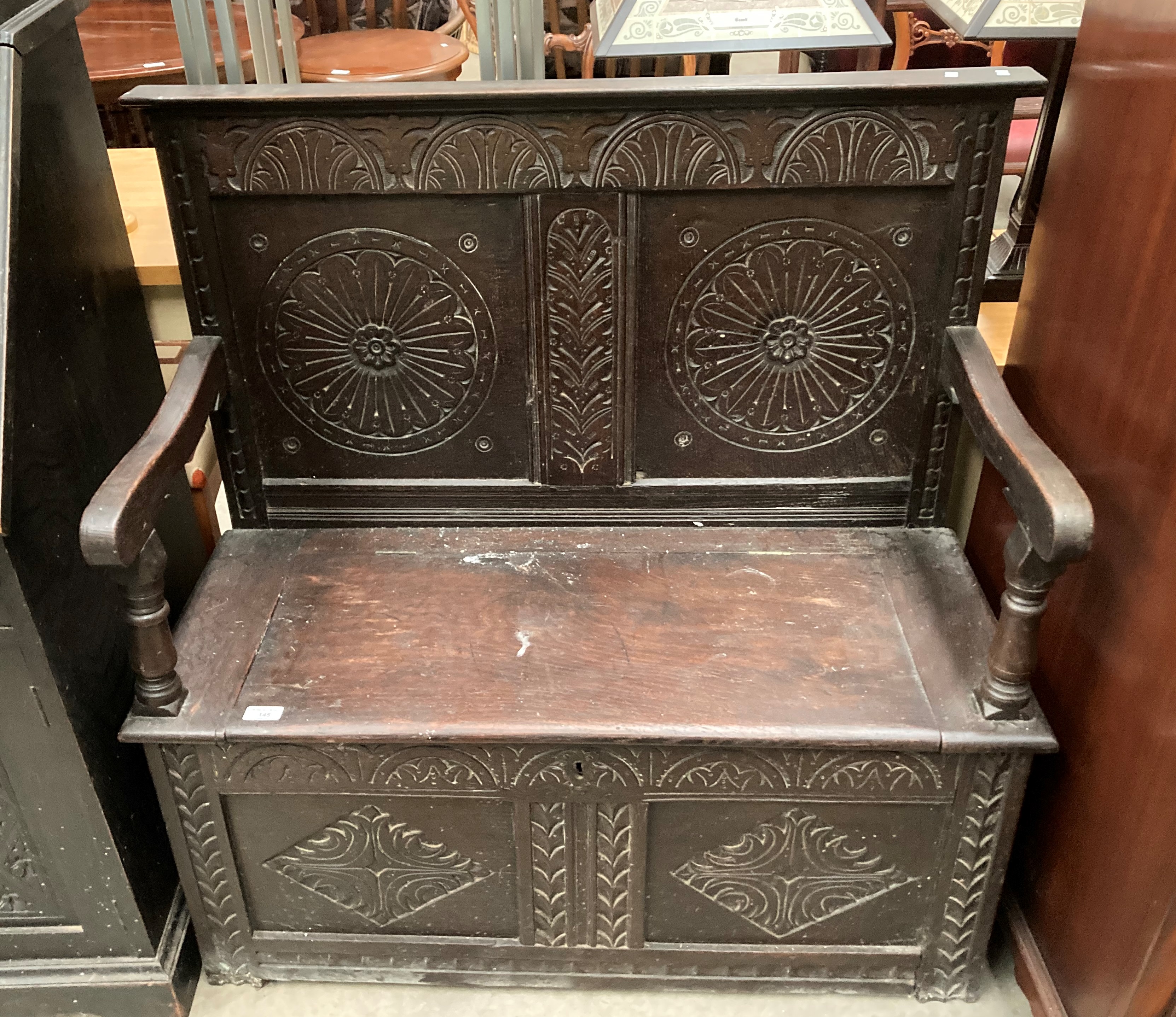 A carved oak settle with lift top seat, - Image 2 of 5