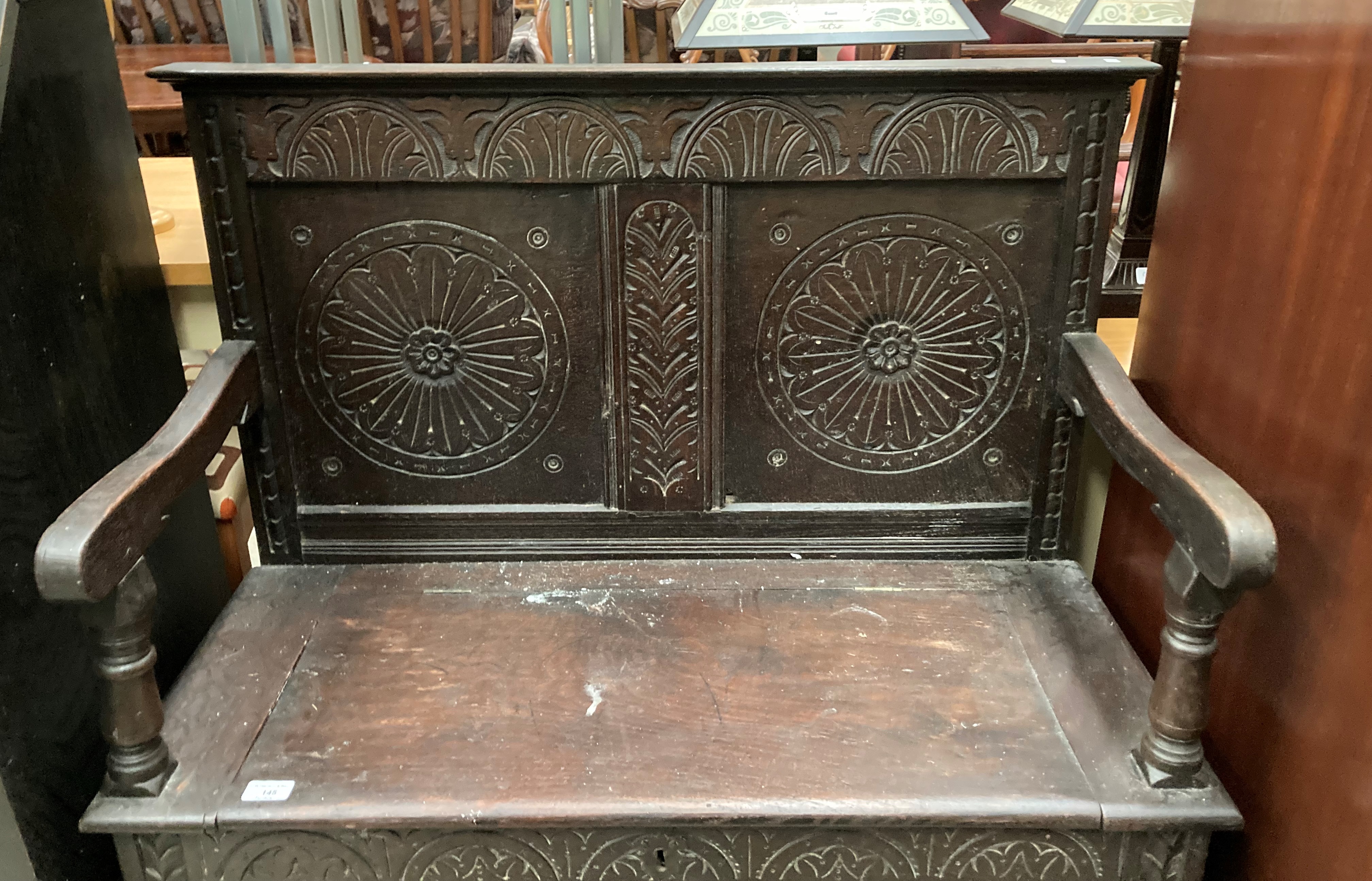 A carved oak settle with lift top seat, - Image 5 of 5