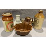 A brown glazed jelly mould, Fentiman's stoneware flagon, Huntley & Palmers Ginger Nuts glazed jar,