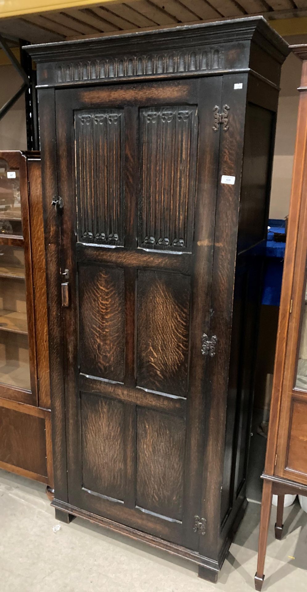 A carved oak single door hall wardrobe,