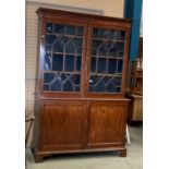 A large mahogany bookcase/wall unit with two Astragal glazed doors over two door base 140cm x 210cm