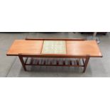 A teak extending top coffee table - when open it reveals a brown patterned tiled centre section
