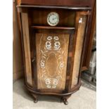 A walnut bow front display cabinet with inset Smiths 30 hour clock,