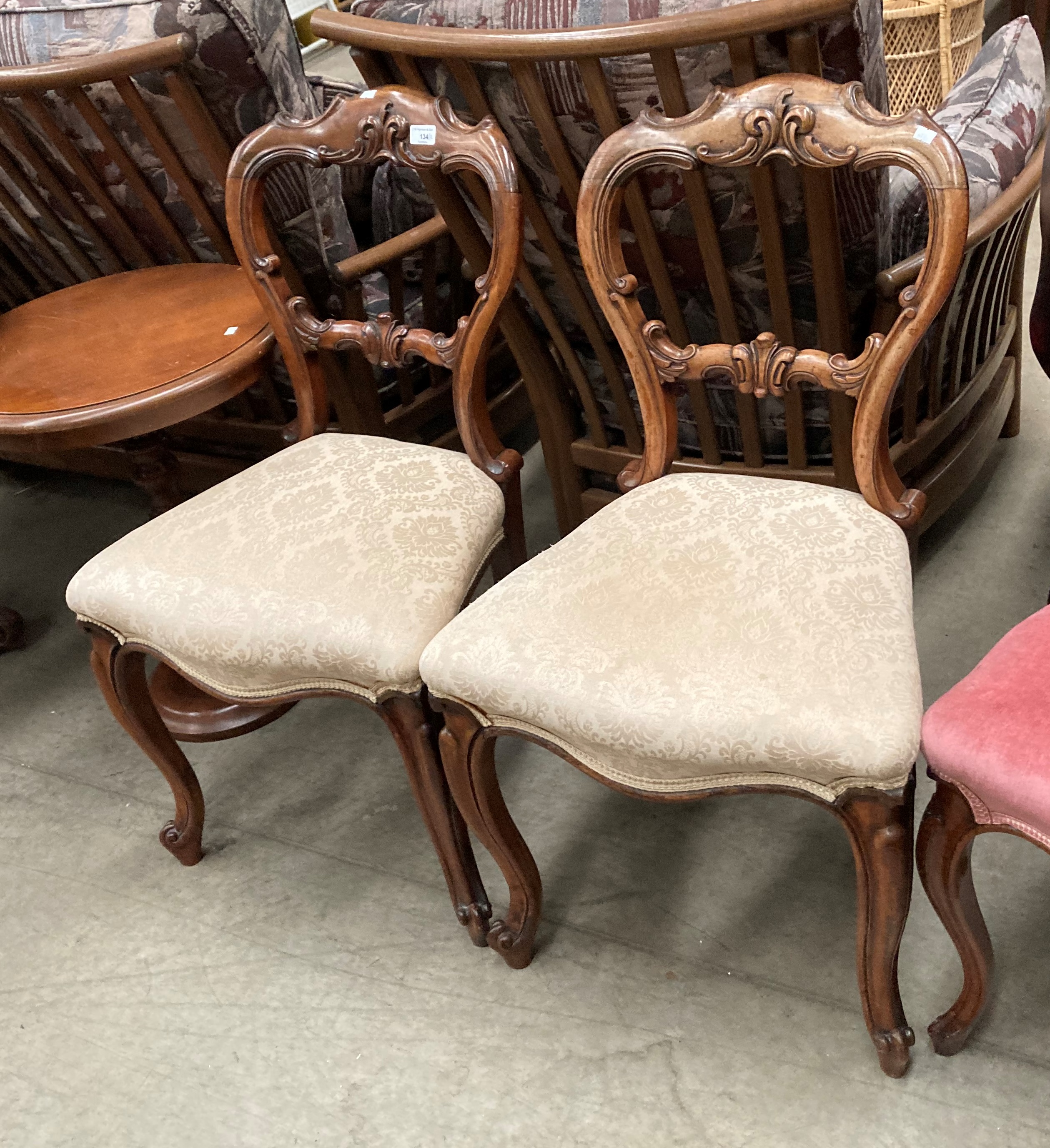 A pair of Victorian mahogany balloon back dining chairs with light brown patterned seats