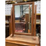 An oak framed swing toilet mirror,
