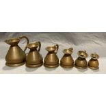 A set of six graduated weights and measures jugs in copper (one pint, half pint, one gill,