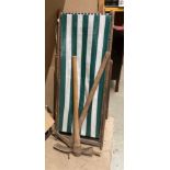 Two wooden framed deck chairs with striped seats,
