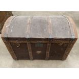 A wood framed brown fibre upholstered dome top trunk,