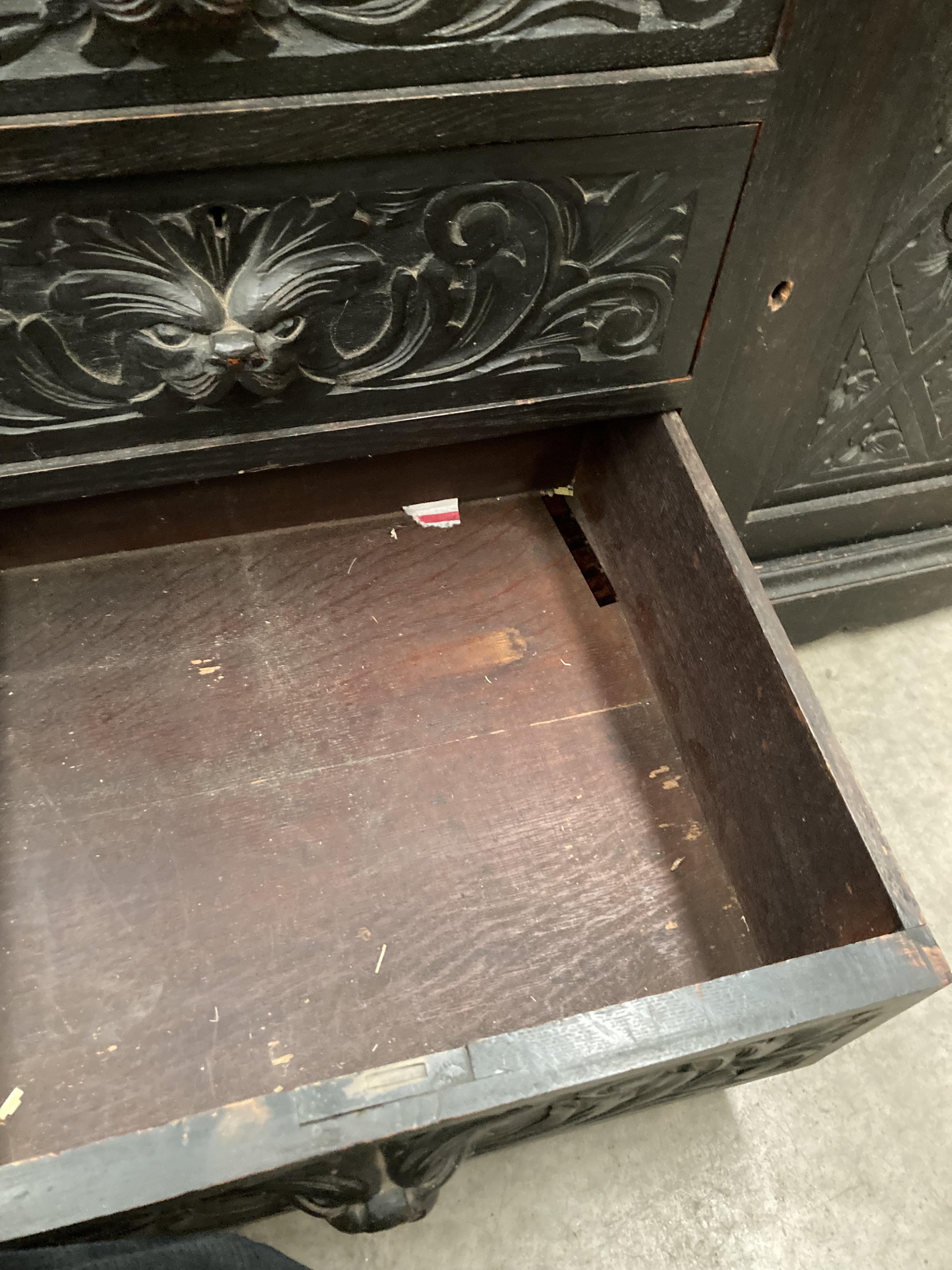 A carved oak bureau with fall flap over four drawer single door base 96cm x 114cm high (part of - Image 5 of 7