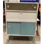 A Remploy white and blue painted vintage kitchen cabinet with two glazed upper sliding doors over