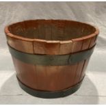 A wooden barrel planter,