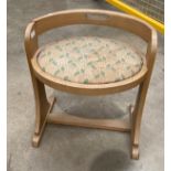 An oak framed oval dressing table stool with green patterned upholstered stool