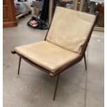 Teak framed lounge chair on tapered circular metal legs - Denmark 1950s with cream vinyl back and