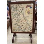 An oak framed folding top tea table/fire screen embroidered with a map of the United Kingdom and