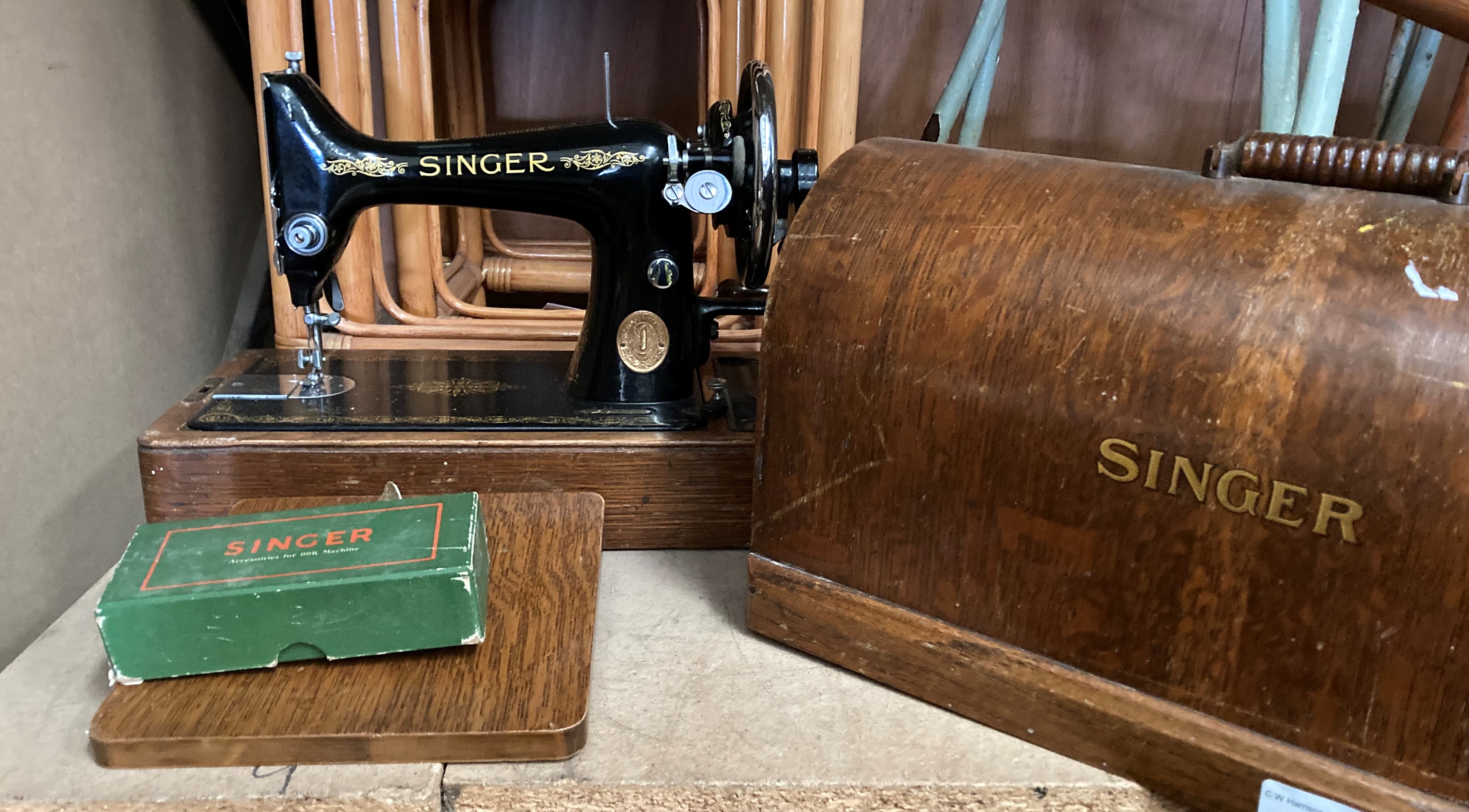 A Singer sewing machine in oak finish portable case complete with accessory pack for a Singer 99K