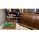 A Singer sewing machine in oak finish portable case complete with accessory pack for a Singer 99K