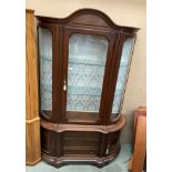 A mahogany bow front display cabinet with single door and two glazed shelves over three drawer two