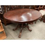 A Victorian walnut tilt top oval loo table with incised decoration to top 85cm x 120cm