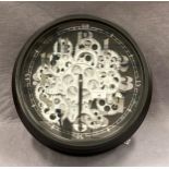 A modern circular battery wall clock depicting cogs - hands appear loose 38cm diameter