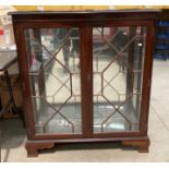 A mahogany finish display cabinet with astragal glazed doors,