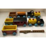Two wooden handmade pull along train sets - three piece and a four piece,