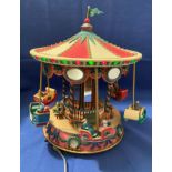 Holiday Fair Merry-Go Round with six chariots and passengers that spin up and out and around in a