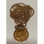 A 1909 half sovereign set in 9ct gold mount and a 9ct gold chain (14 grams in total)