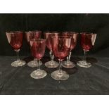 Two cranberry wine glasses with cut glass stems,