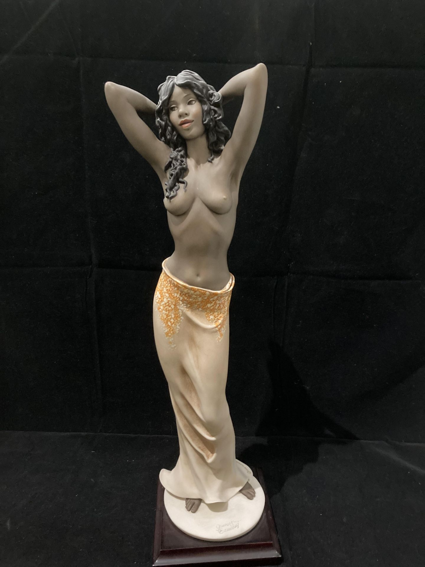 A Florence Guiseppe Armani figurine of a half naked female with signature to base 44cm high