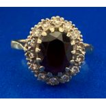 An 18ct yellow gold oval sapphire and sixteen diamond cluster ring - total weight 5.