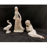 A Nao porcelain figurine of a girl feeding a goose 23cm high,